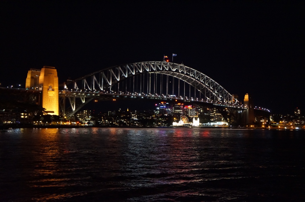 Sydney Harbour Bridge at night, lit up by artificial lights.